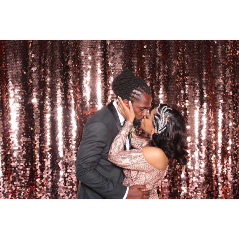 photo of married couple kissing in front of sparkling background