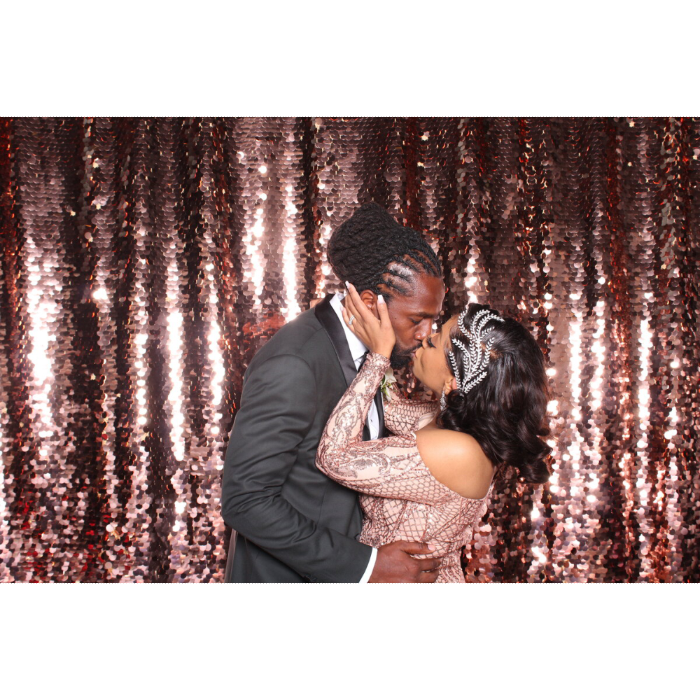 photo of married couple kissing in front of sparkling background