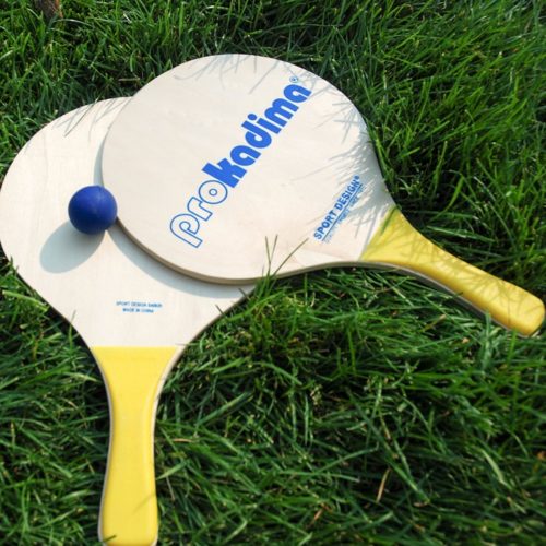paddles and ball on grass